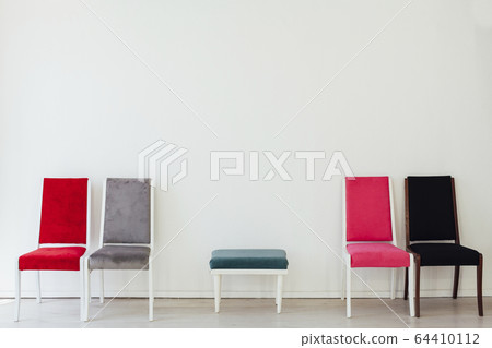 lots of different chairs in the interior of the white room 64410112