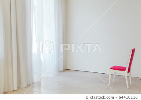 one red chair in the interior of an empty white office 64410116