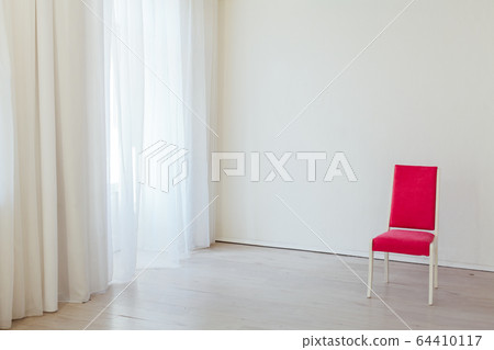 one red chair in the interior of an empty white office 64410117