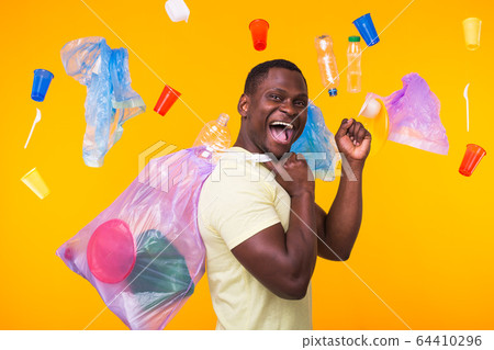 Problem of trash, plastic recycling, pollution and environmental concept - funny man carrying garbage bag on yellow background Problem of trash, plastic recycling, pollution and environmental concept - funny man carrying garbage bag on yellow background 64410296
