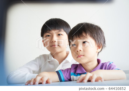Boy staring at the monitor Boy staring at the monitor 64410852