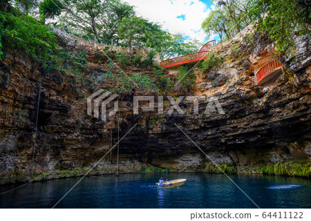 Cenote Ecoturistico X-cajum with blue clear water. 64411122