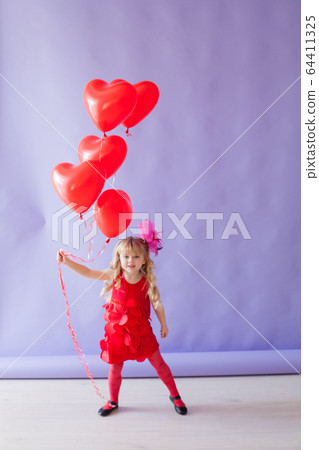 little beautiful girl on holiday with red heart-shaped balloons little beautiful girl on holiday with red heart-shaped balloons 64411325