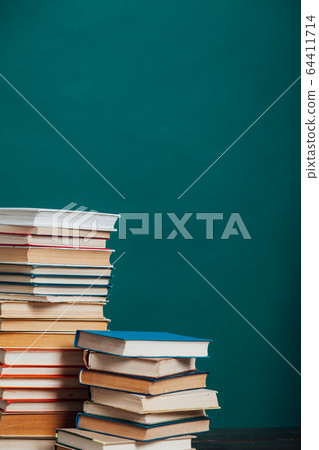 school a lot of different educational books on a green background 64411714