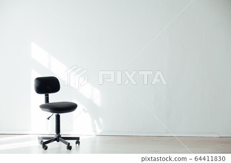 black office chair in an empty white office black office chair in an empty white office 64411830