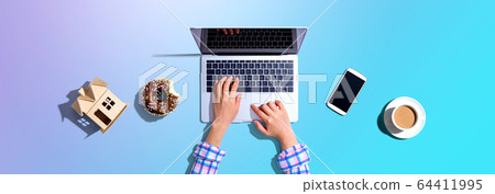 Woman using a laptop computer Woman using a laptop computer 64411995