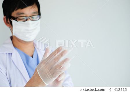 doctor wearing glove to prevent coronavirus and doctor wearing glove to prevent coronavirus and 64412313