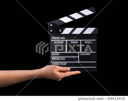 Human hand holding film clapper board isolated on black background 64412434