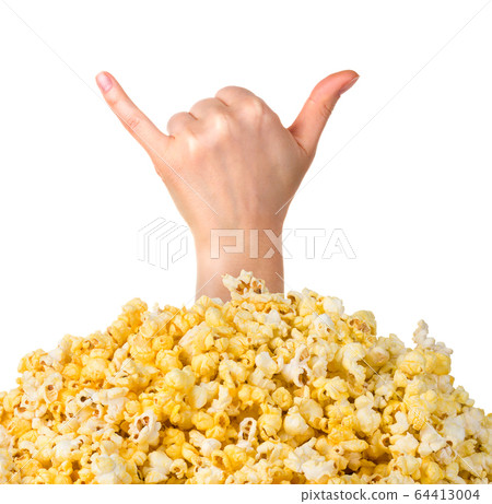 Female hand sticks out of a pile of popcorn isolated on white background Female hand sticks out of a pile of popcorn isolated on white background 64413004