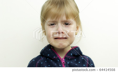 Portrait of little child girl crying with tears on her eyes. White background 64414508