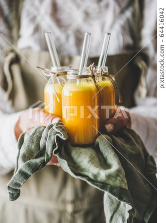 Woman holding bottles with fruit vitamin immune Woman holding bottles with fruit vitamin immune 64416042