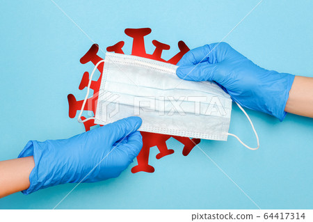 Two hands in latex gloves and medical mask against 64417314