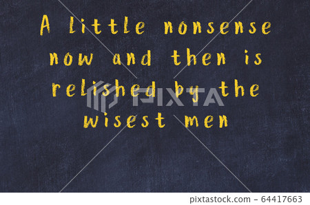 Chalk inscription of smart quote on black desk 64417663