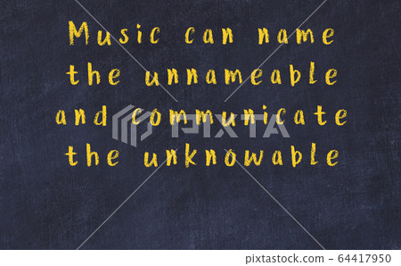 Chalk inscription of smart quote on black desk 64417950