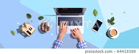 Woman using a laptop computer Woman using a laptop computer 64418389