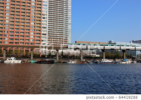 Tokyo Monorail train in front of highrise apartment by Tokyo Bay Tokyo Monorail train in front of highrise apartment by Tokyo Bay 64419288