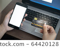 Close up hand of women holding credit card and smartphone for payment shopping online in smart life concept 64420128