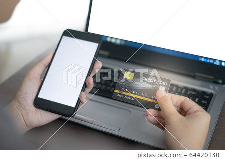 Close up hand of women holding credit card and smartphone for payment shopping online in smart life concept 64420130