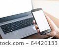 Close up hand of women using smartphone and laptop in working concept 64420133