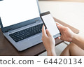 Close up hand of women using smartphone and laptop in working concept 64420134