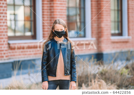 Girl wearing a mask protect against Coronavirus and gripp 64422856