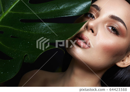 beautiful wet girl in palms. Beautiful woman with 64423388
