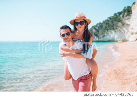 Young couple on white beach during summer vacation. Young couple on white beach during summer vacation. 64423763