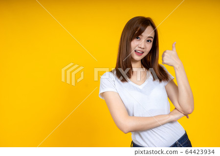 Close up of young Asian woman isolated on yellow Close up of young Asian woman isolated on yellow 64423934