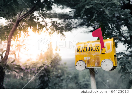 Closeup yellow old mailbox on a natural background Closeup yellow old mailbox on a natural background 64425013