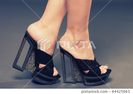 Fashionable woman slender legs in tights black Fashionable woman slender legs in tights black 64425663