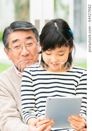 Tablet grandpa and grandson 64427082
