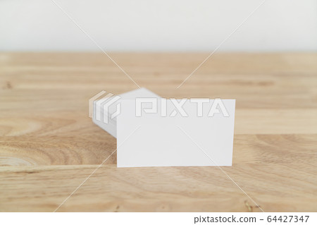 Blank business cards on wooden surface. 64427347