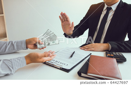 Business person refusing bribe given money by 64427697