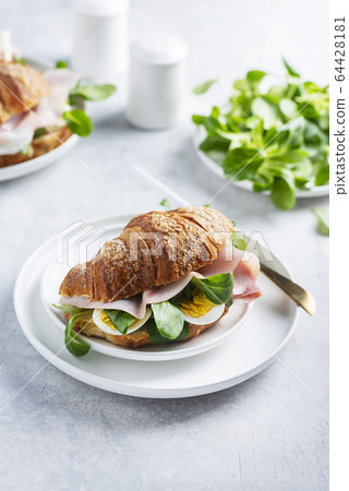 Fresh croissant with green salad Fresh croissant with green salad 64428181