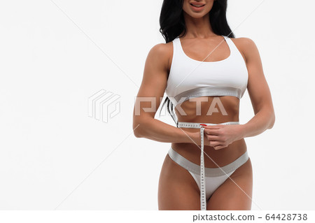 Beautiful woman with tape measure 64428738