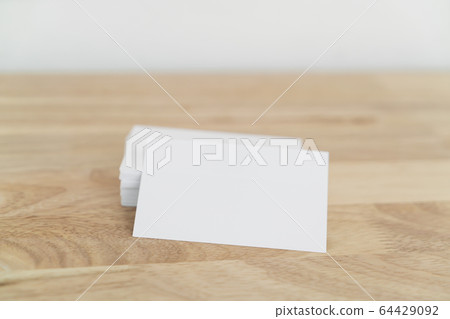 Blank business cards on wooden surface. 64429092