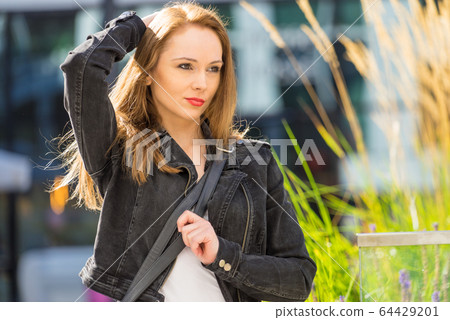 Fashion woman in city wearing romenes jacket. 64429201