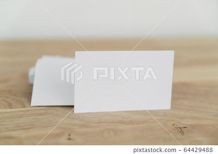 Blank business cards on wooden surface. 64429488