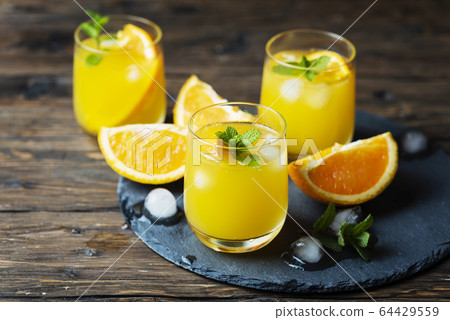 Fresh summer cocktail with orange and mint Fresh summer cocktail with orange and mint 64429559