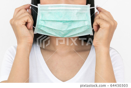 A woman wears a face mask that protects against the spread of Coronavirus 64430303