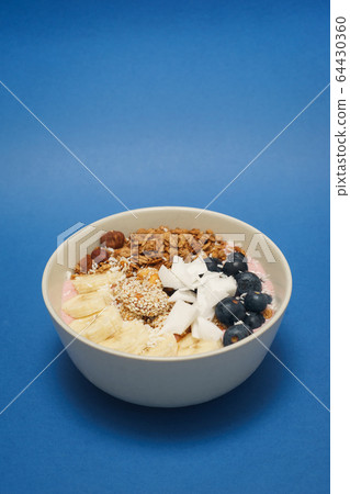 Handmade Bowl healthy tasty breakfast of yogurt, smoothie with granola, nuts, bananas and berries Handmade Bowl healthy tasty breakfast of yogurt, smoothie with granola, nuts, bananas and berries 64430360