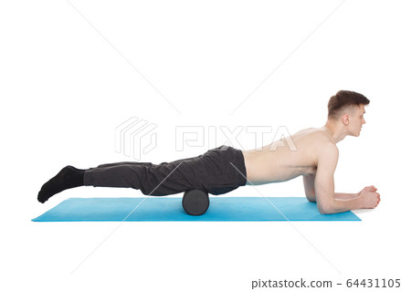 Handsome man shows exercises using a foam roller 64431105