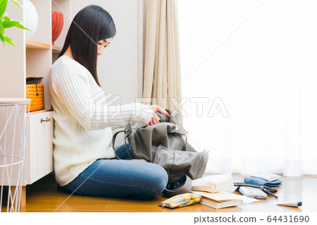 A woman putting her hand in her back 64431690