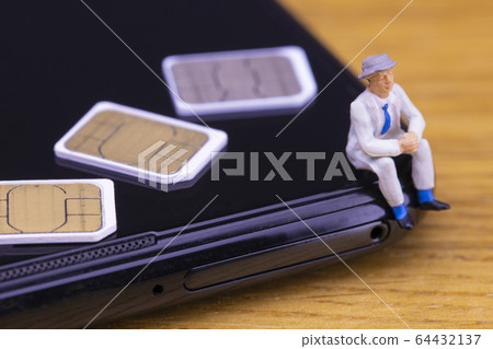 Businessman thinking about contract on smartphone Businessman thinking about contract on smartphone 64432137