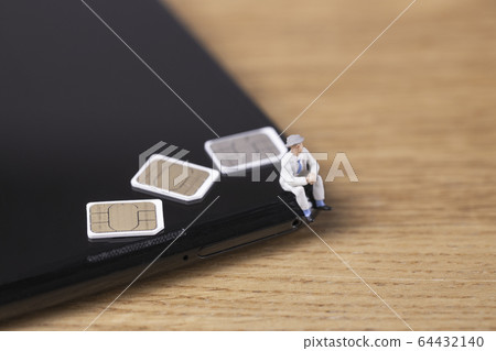 Businessman thinking about contract on smartphone 64432140