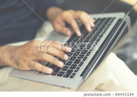 lifestyle man close up hand keyboard sit work on sofa 64433184