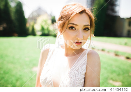 Beautiful fashion bride in wedding dress posing 64434562