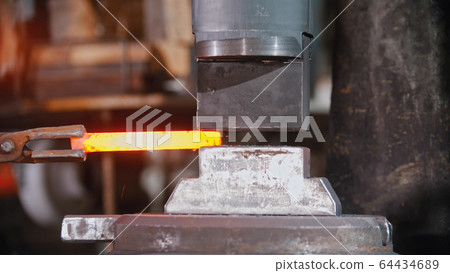 Forging an item out of hot metal using a pressure machine 64434689