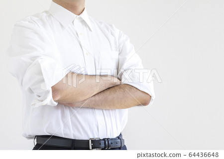 A man in a shirt rolling his arms and crossing his arms 64436648