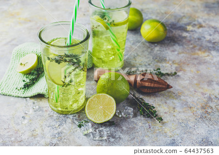 Lime Lemonade with thyme and ice. 64437563